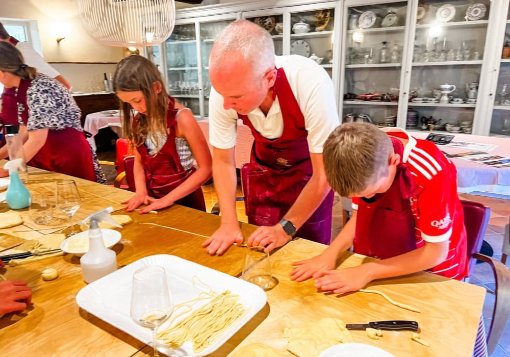family making pasta in cooking class